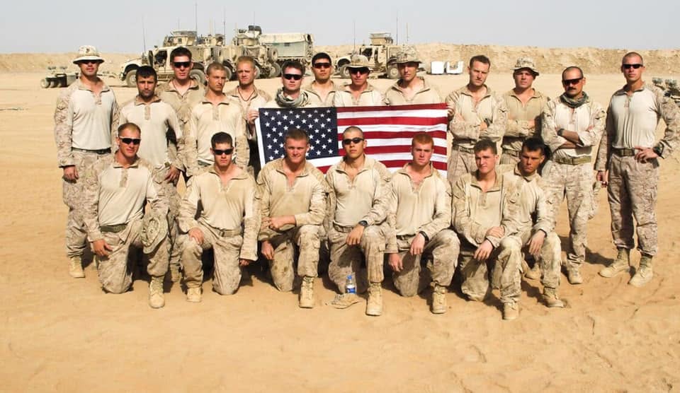 Members of 1st Reconnaissance Battalion holding an American flag
